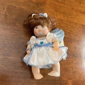 Classic Creations Porcelain Birthstone Angel doll with Light Blue Wings
